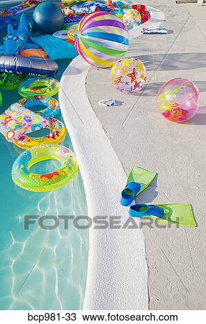 Swimming pool full of inflatable toys View Large Photo Image Stock Image - Swimming pool full of inflatable toys. Fotosearch