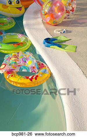 Swimming pool full of inflatable toys View Large Photo Image Stock Photograph - Swimming pool full of inflatable toys. Fotosearch