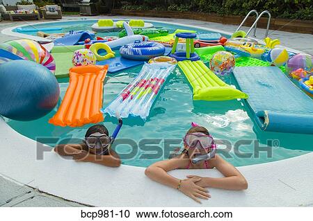 Two children wearing scuba masks and snorkels swim in a pool full of inflatable toys View Large Photo Image Stock Image - Two children wearing scuba masks and snorkels swim in a pool full of inflatable toys. Fotosearch
