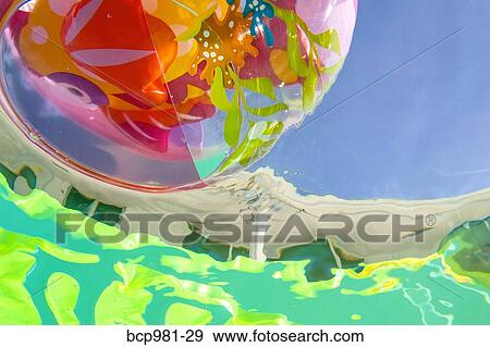 Underwater view of a beach ball in a pool View Large Photo Image Stock Photo - Underwater view of a beach ball in a pool. Fotosearch