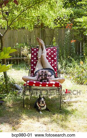 Woman with rollers in her hair lounges in her garden with a Boston Terrier View Large Photo Image Stock Image - Woman with rollers in her hair lounges in her garden with a Boston Terrier. Fotosearch