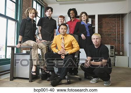 A group of seven young colleagues in an office. View Large Photo Image Stock Image - A group of seven young colleagues in an office.. Fotosearch