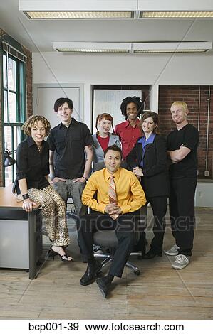 A group of seven young colleagues in an office. View Large Photo Image Stock Photo - A group of seven young colleagues in an office.. Fotosearch