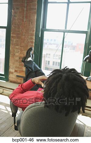 A man talking on the phone while gazing out his office window. View Large Photo Image Stock Photograph - A man talking on the phone while gazing out his office window.. Fotosearch