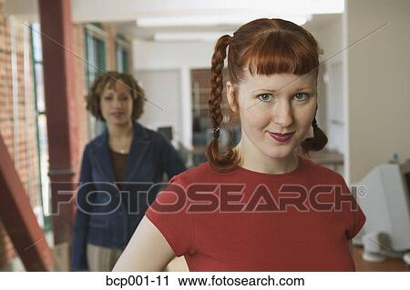 Close-up of a young business woman and co-worker. View Large Photo Image Stock Image - Close-up of a young business woman and co-worker.. Fotosearch