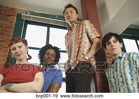 Group portrait of young colleagues in a loft-style office. View Large Photo Image Stock Photo - Group portrait of young colleagues in a loft-style office.. Fotosearch