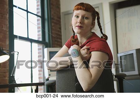 Portrait of a red-haired woman in her office. View Large Photo Image Picture - Portrait of a red-haired woman in her office.. Fotosearch