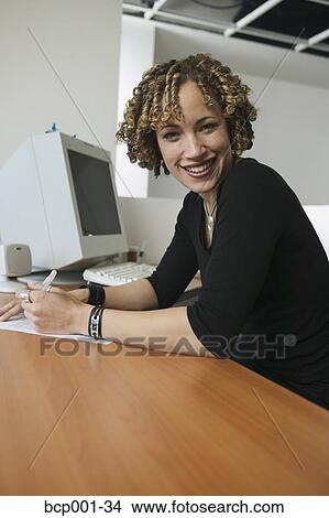 Portrait of a young, smiling businesswoman. View Large Photo Image Picture - Portrait of a young, smiling businesswoman.. Fotosearch