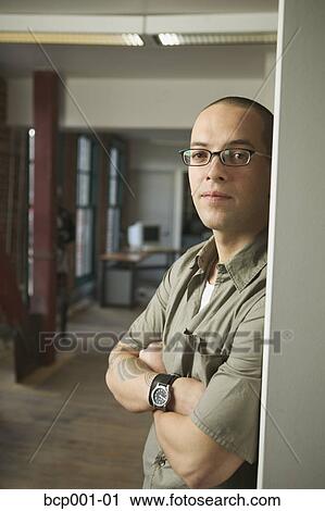 Two young men standing in a loft-style office. View Large Photo Image Stock Image - Two young men standing in a loft-style office.. Fotosearch