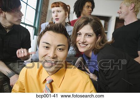 Young male and female co-workers. View Large Photo Image Stock Image - Young male and female co-workers.. Fotosearch