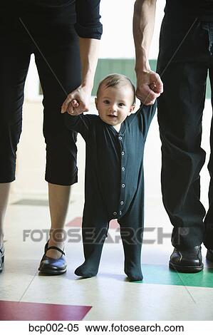 A baby taking first steps. View Large Photo Image Stock Photography - A baby taking first steps. . Fotosearch