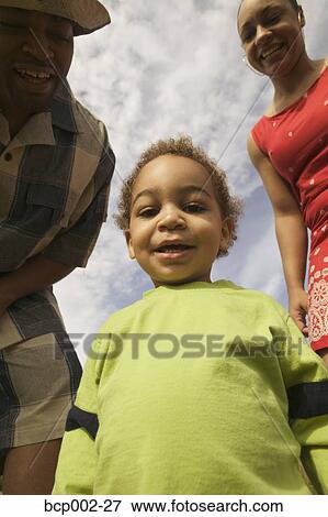 Stock Photo - A male toddler and his parents. . Fotosearch