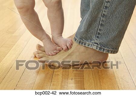 Closeup of a man in blue jeans with his baby's bare feet on his. View Large Photo Image Stock Image - Closeup of a man in blue jeans with his baby's bare feet on his. . Fotosearch