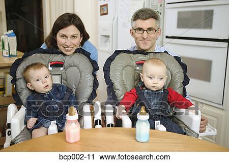 Parents with their twin babies. View Large Photo Image Stock Image - Parents with their twin babies.. Fotosearch