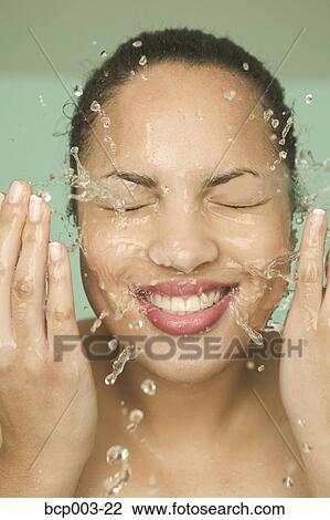 A smiling woman washing her face. View Large Photo Image Stock Image - A smiling woman washing her face.. Fotosearch
