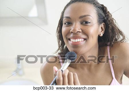 A woman applying make-up to her chin. View Large Photo Image Stock Image - A woman applying make-up to her chin.. Fotosearch