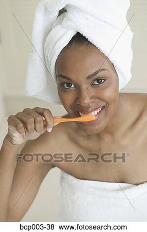 A woman brushing her teeth. View Large Photo Image Stock Photo - A woman brushing her teeth.. Fotosearch