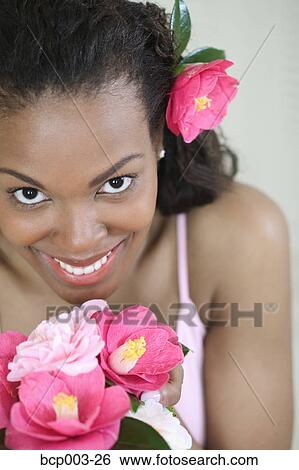 A woman holding a bouquet of flowers. View Large Photo Image Stock Photograph - A woman holding a bouquet of flowers.. Fotosearch