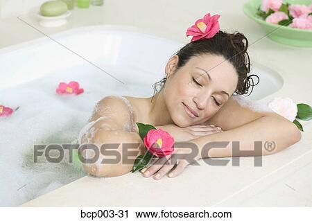 A woman relaxes in a bathtub full of bubbles. View Large Photo Image Stock Image - A woman relaxes in a bathtub full of bubbles.. Fotosearch