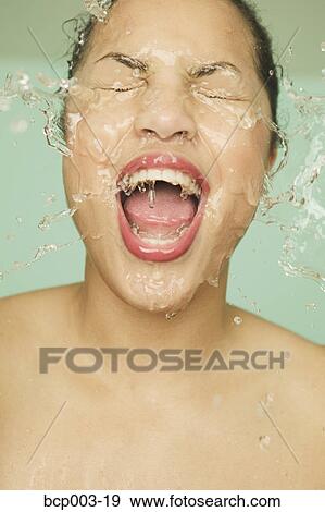 Close-up of a woman washing her face. View Large Photo Image Stock Photo - Close-up of a woman washing her face.. Fotosearch