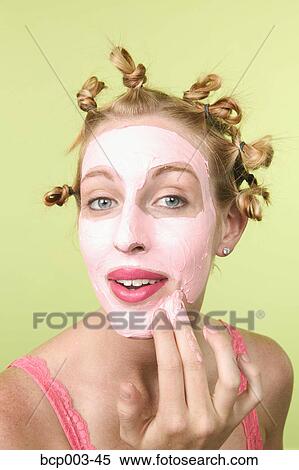 Woman applying a facial mask. View Large Photo Image Stock Photography - Woman applying a facial mask.. Fotosearch