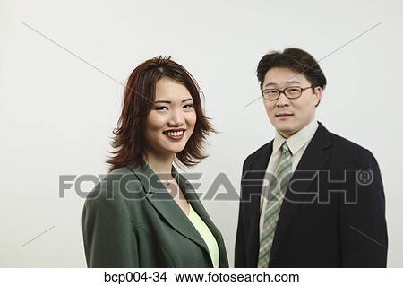 A man and woman in business clothes. View Large Photo Image Picture - A man and woman in business clothes.. Fotosearch