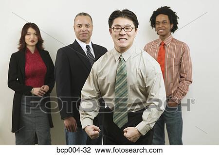 A young businessman flexing his muscles in front of his colleagues. View Large Photo Image Stock Image - A young businessman flexing his muscles in front of his colleagues.. Fotosearch