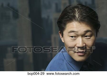 Stock Photo - A young businessman posing in a studio.. Fotosearch