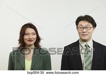 Businessman and woman looking at each other. View Large Photo Image Stock Photography - Businessman and woman looking at each other.. Fotosearch