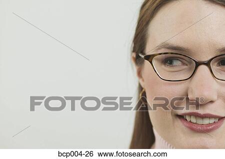 Cropped portrait of a young woman wearing glasses. View Large Photo Image Stock Photograph - Cropped portrait of a young woman wearing glasses. . Fotosearch