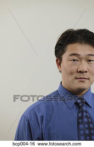 Stock Photograph - Cropped studio portrait of a young businessman. . Fotosearch