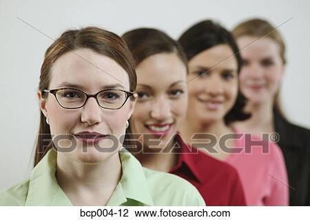 Stock Image - Four young businesswomen. . Fotosearch
