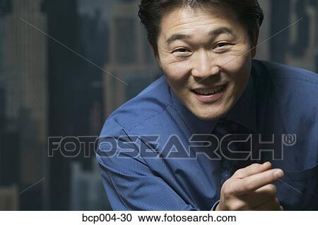 Stock Image - Portrait of a man in a blue shirt. . Fotosearch