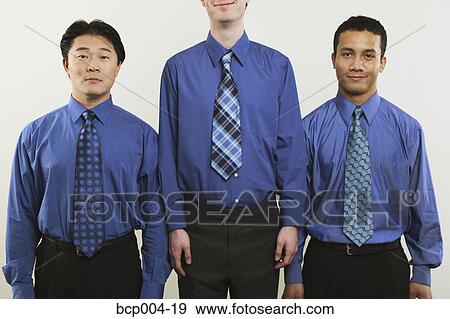 Stock Photo - Studio portrait of three young businessmen. . Fotosearch