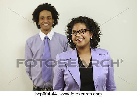 Studio portrait of two business people. View Large Photo Image Picture - Studio portrait of two business people.. Fotosearch