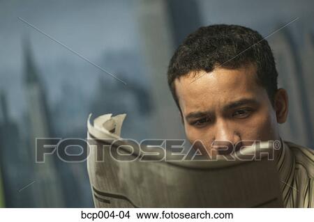 Young businessman reading the newspaper. View Large Photo Image Picture - Young businessman reading the newspaper. . Fotosearch