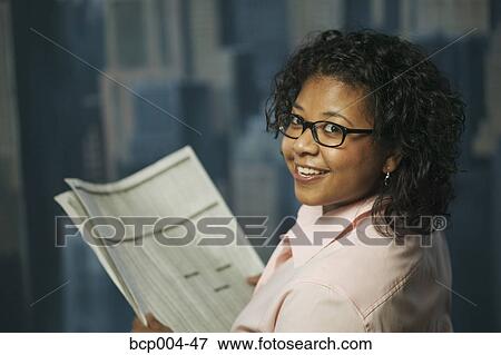 Young woman reading financial news. View Large Photo Image Stock Photo - Young woman reading financial news.. Fotosearch