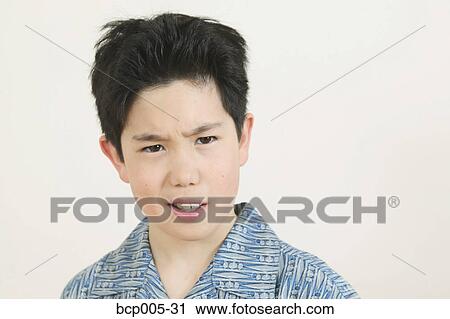 Stock Image - A teenage boy with a puzzled expression. . Fotosearch