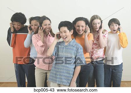 Seven teenagers talking on mobile phones. View Large Photo Image Stock Image - Seven teenagers talking on mobile phones. . Fotosearch