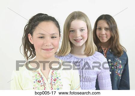 Stock Photo - Studio portrait of three teenage girls. . Fotosearch