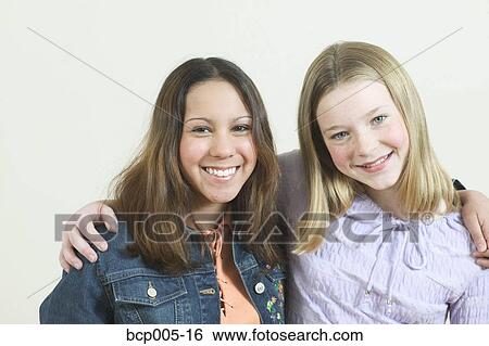 Studio portrait of two teenage friends. View Large Photo Image Stock Photograph - Studio portrait of two teenage friends.. Fotosearch