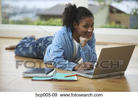 Teenage girl working on a laptop computer. View Large Photo Image Stock Photo - Teenage girl working on a laptop computer. . Fotosearch