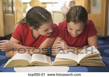 Twin teenage girls doing their homework together. View Large Photo Image Stock Image - Twin teenage girls doing their homework together. . Fotosearch