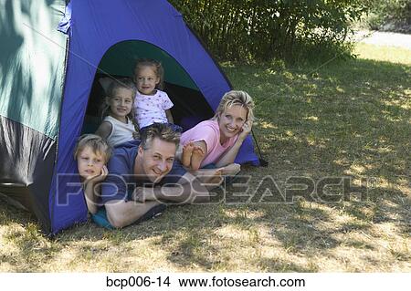 Caucasian family looking out of tent at campsite. View Large Photo Image Picture - Caucasian family looking out of tent at campsite.. Fotosearch
