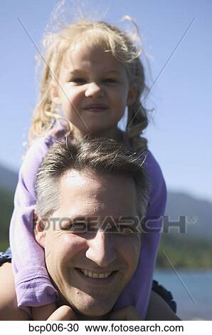 Dad with young daughter on his shoulders. View Large Photo Image Stock Image - Dad with young daughter on his shoulders.. Fotosearch