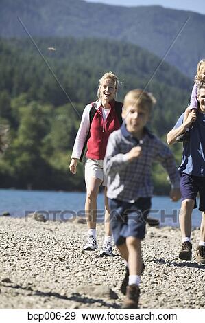 Stock Photo - Family hiking near a lake.. Fotosearch