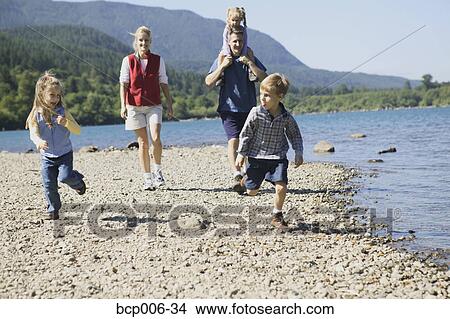 Family hiking next to a lake. View Large Photo Image Picture - Family hiking next to a lake.. Fotosearch