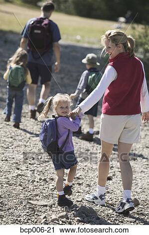 Stock Image - Family of five setting off on a hike.. Fotosearch