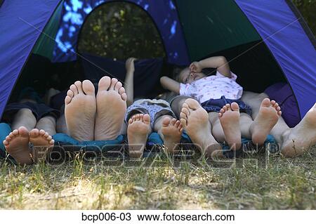 Family's feet sticking out of tent on camping trip. View Large Photo Image Stock Image - Family's feet sticking out of tent on camping trip.. Fotosearch
