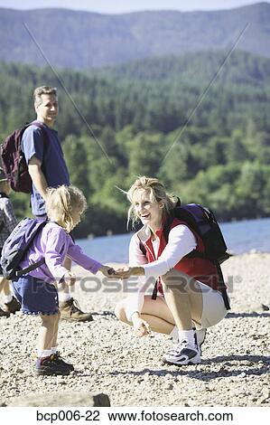Mother helping young child on a hike. View Large Photo Image Stock Image - Mother helping young child on a hike.. Fotosearch